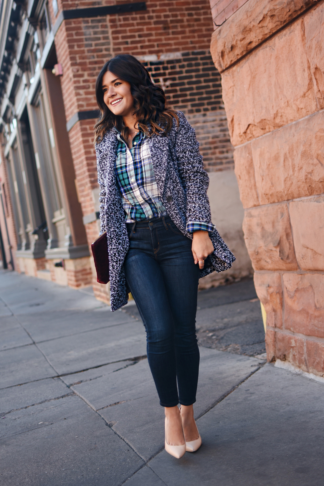 Carolina Hellal of Chic Talk wearing Old Navy rockstar skinny jeans, Dark grey coat, plaid top and Burgundy velvet clutch - STYLING OLD NAVY DENIM by popular Denver fashion blogger Chic Talk