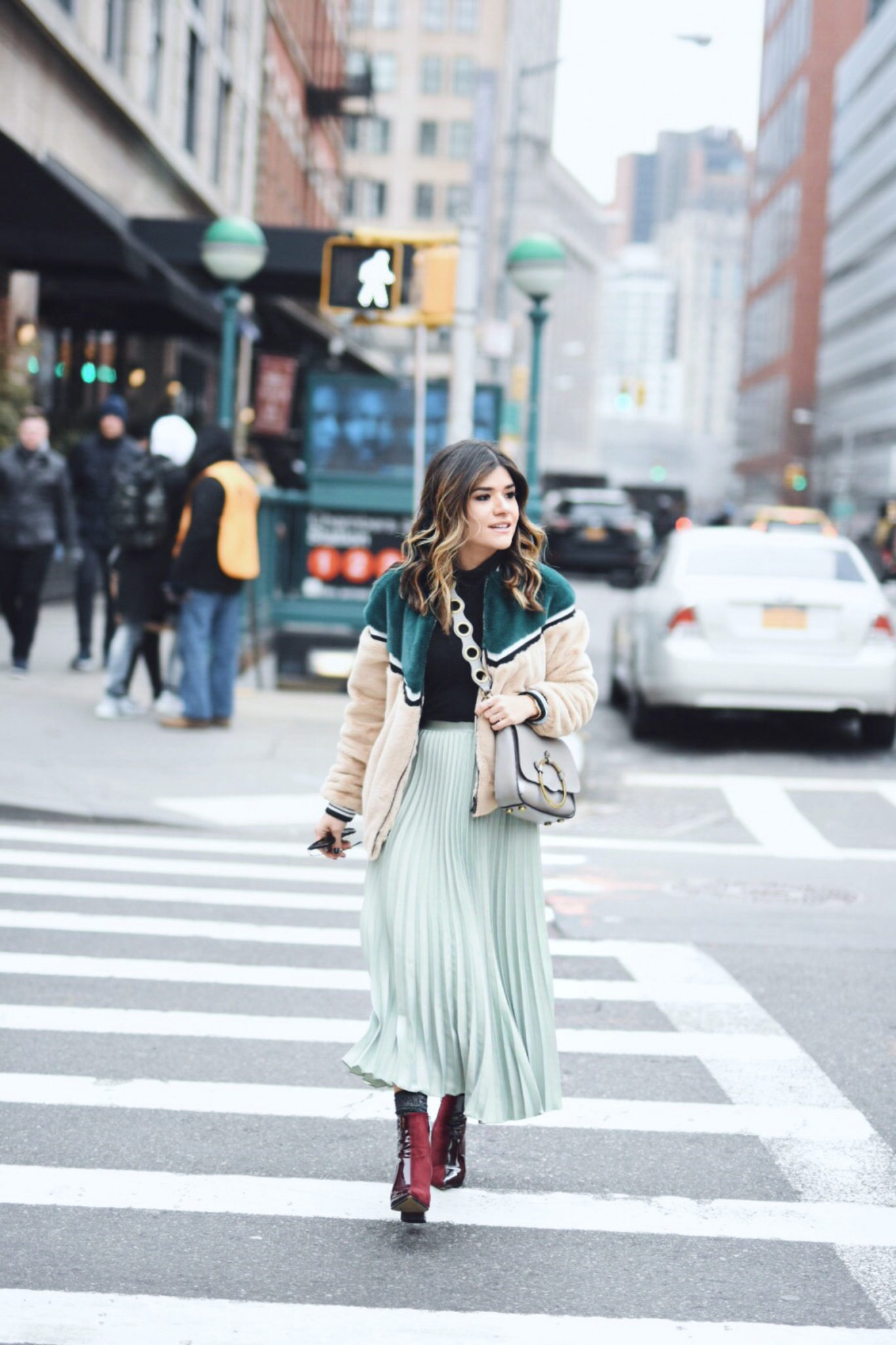 Carolina Hellal of Chic Talk wearing an H&M pleated skirt, Shein bomber jacket, Public Desire boots and Rebecca Minkoff bag - NYFW 2018 DAY 2 AND 3 by popular Denver fashion blogger Chic Talk