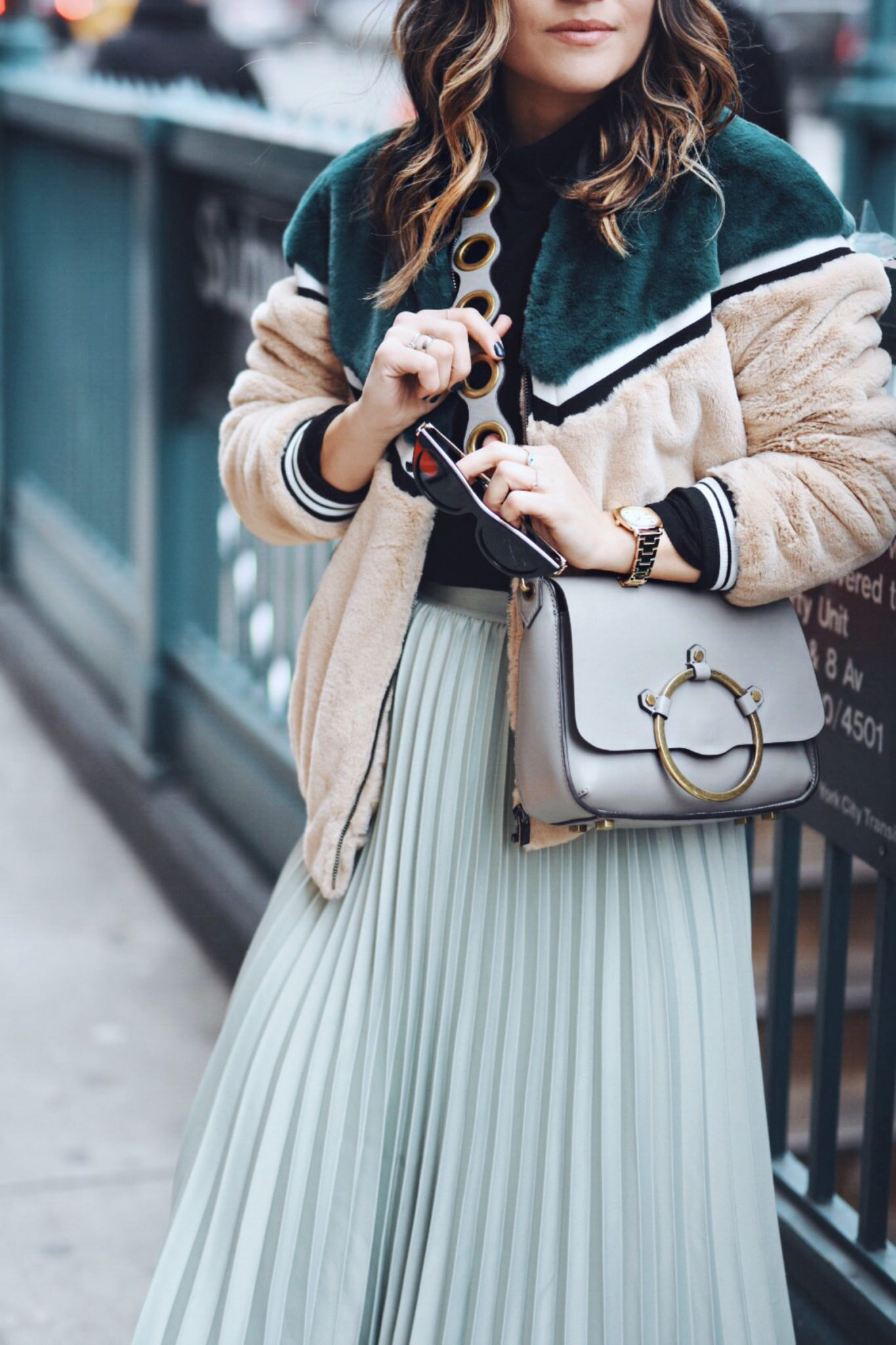 Carolina Hellal of Chic Talk wearing an H&M pleated skirt, Shein bomber jacket, Public Desire boots and Rebecca Minkoff bag - NYFW 2018 DAY 2 AND 3 by popular Denver fashion blogger Chic Talk