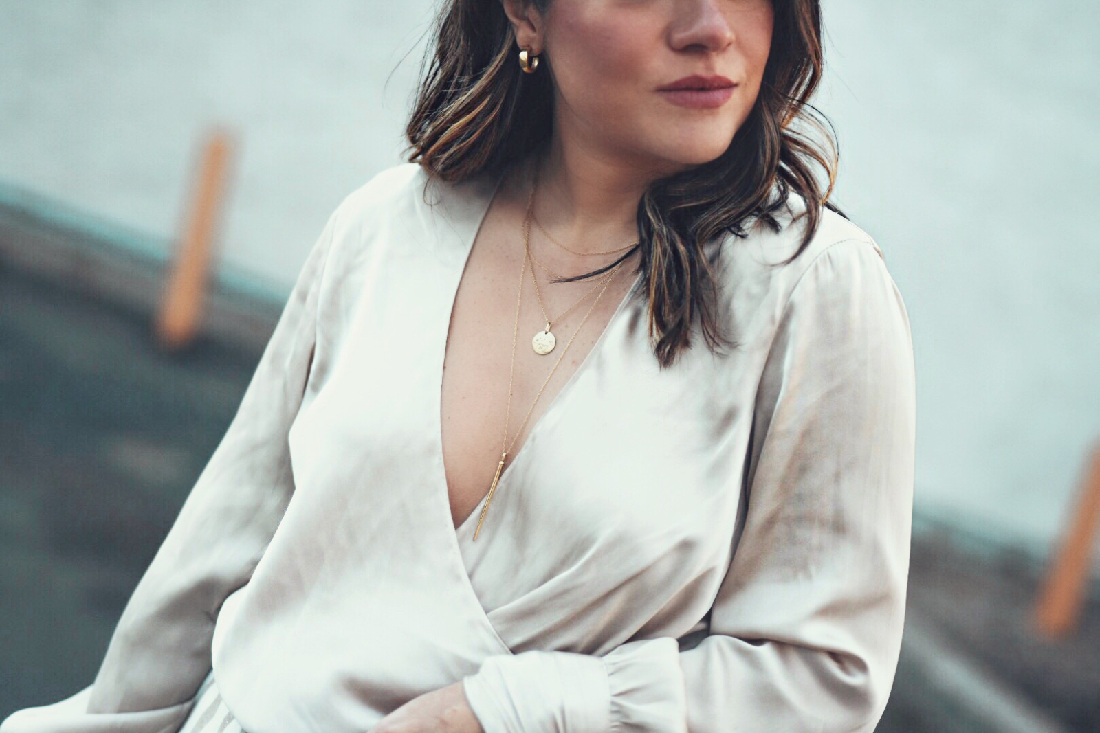 Carolina Hellal wears the Chriselle Lim x J.O.A wide leg pants, h&m silk top and JADEtribe mini pom pom bag - STYLING WIDE LEG PANTS FOR SPRING by popular Denver fashion blogger Chic Talk