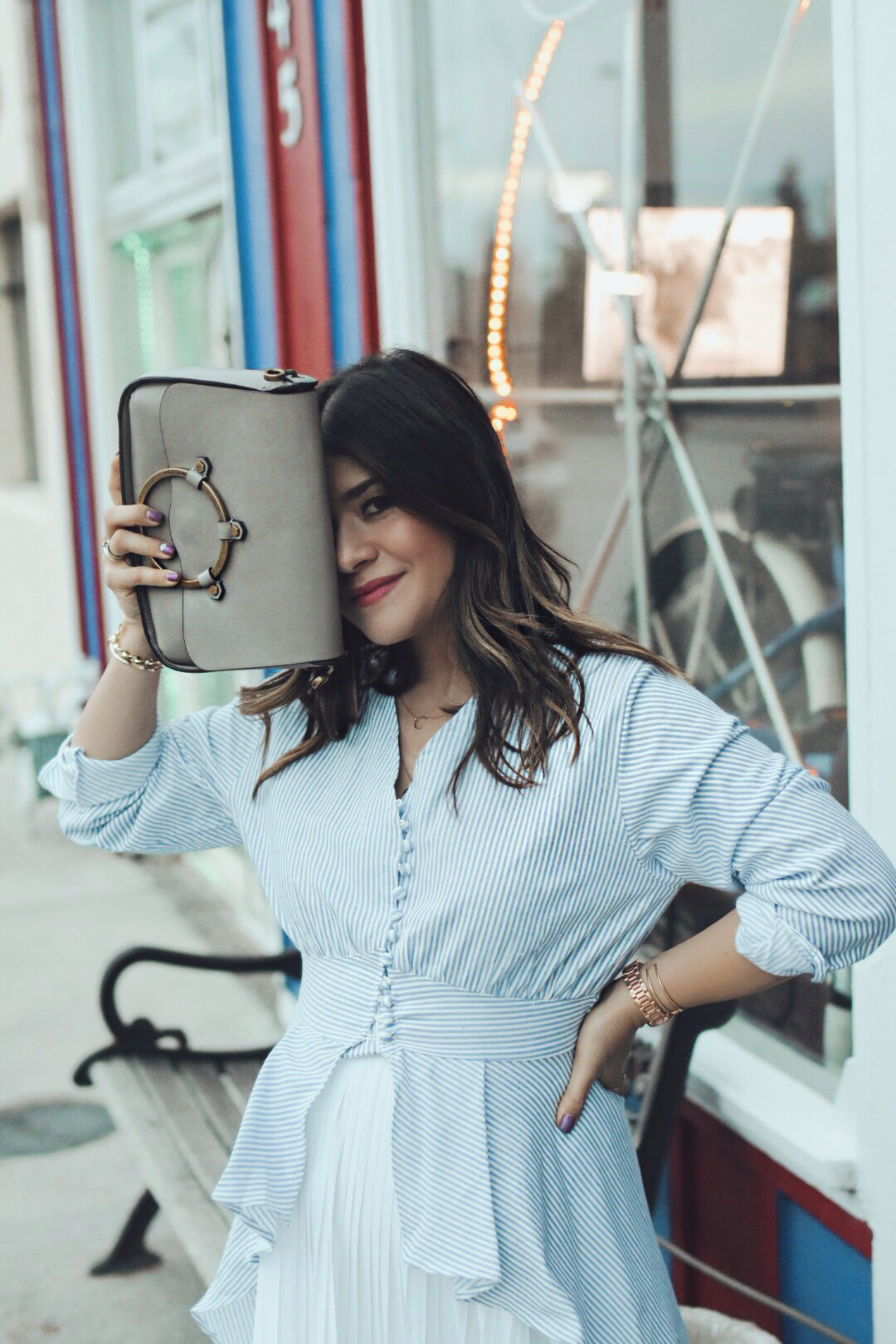 Carolina Hellal of Chic Talk wearing a Chicwish striped long top, a white midi skirt, and Vince Camuto sandals.